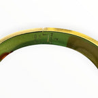 Hermès Clic H bracelet in black enamel with yellow-gold-tone hardware, with the signature “H” toggle clasp.
