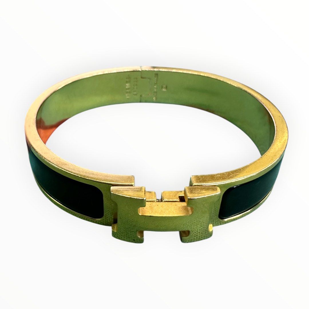 Hermès Clic H bracelet in black enamel with yellow-gold-tone hardware, with the signature “H” toggle clasp.