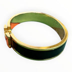 Hermès Clic H bracelet in black enamel with yellow-gold-tone hardware, with the signature “H” toggle clasp.