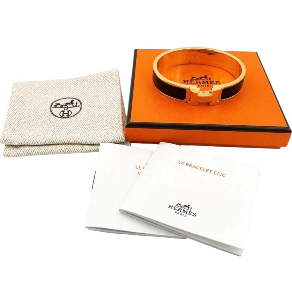 Hermès Clic H bracelet in black enamel with yellow-gold-tone hardware, with the signature “H” toggle clasp.